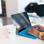 person using blue Microsoft Surface