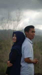 man and woman standing beside grasses