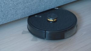 a black robot vacuum on a wooden floor