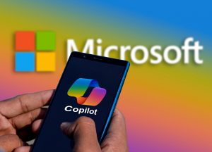 a person holding a cell phone in front of a microsoft logo