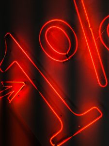 a red neon sign with a black background