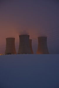 a group of cooling towers in the snow