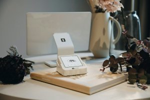 Square reader setup on a desk with a computer.