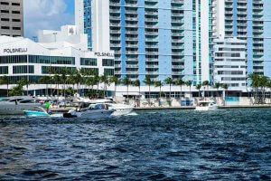Modern buildings and boats sit by the water.