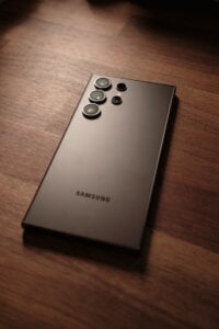 a close up of a cell phone on a wooden surface